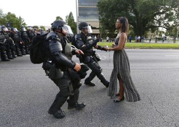 BEST QUALITY AVAILABLE - Protestor Ieshia Evans is detained by law enforcement near the headquarters of the Baton Rouge Police Department in Baton Rouge, Louisiana, U.S. July 9, 2016. REUTERS/Jonathan Bachman - HT1EC7R05L9MR